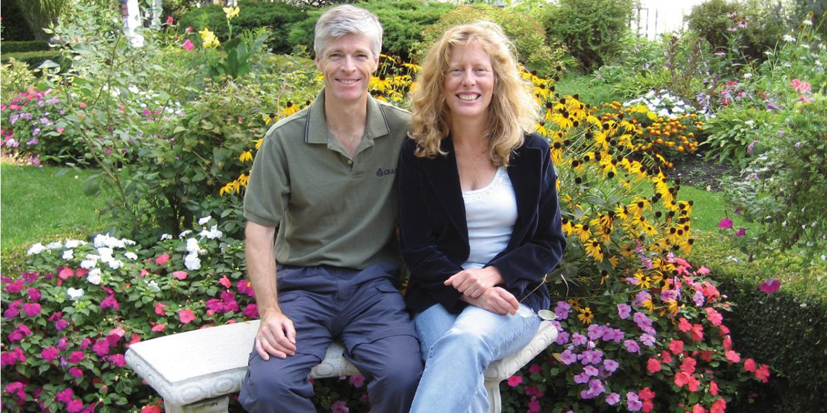 After stroke middle-aged couple participants sitting together in their garden smiling