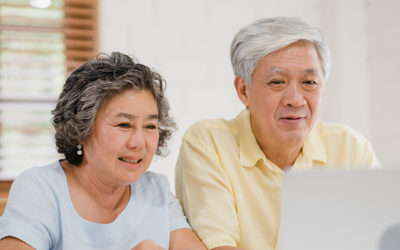 Two older people looking at a computer