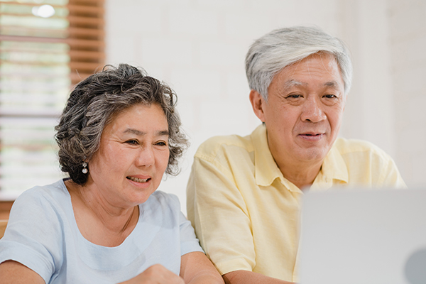 Two older people looking at a computer