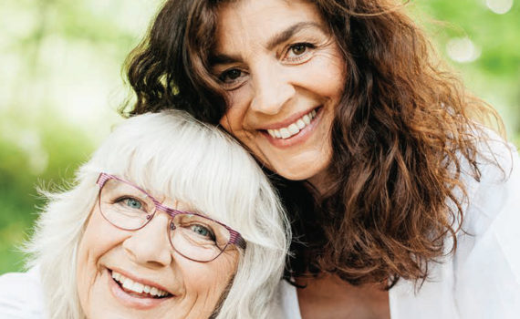 smiling older mother and daughter