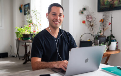 Smiling stroke survivor Jonathan typing on laptop