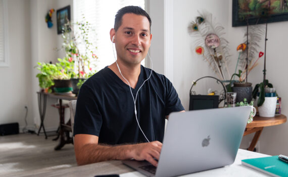 Smiling stroke survivor Jonathan typing on laptop